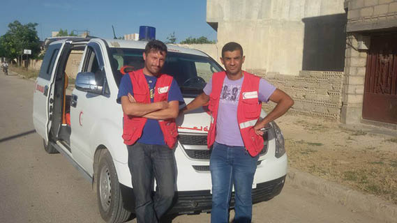 Calvin and colleague sitting on ambulance